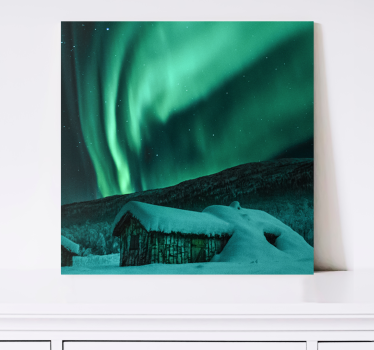Tableau avec des aurores boréales au-dessus d'un chalet enneigé - TenStickers